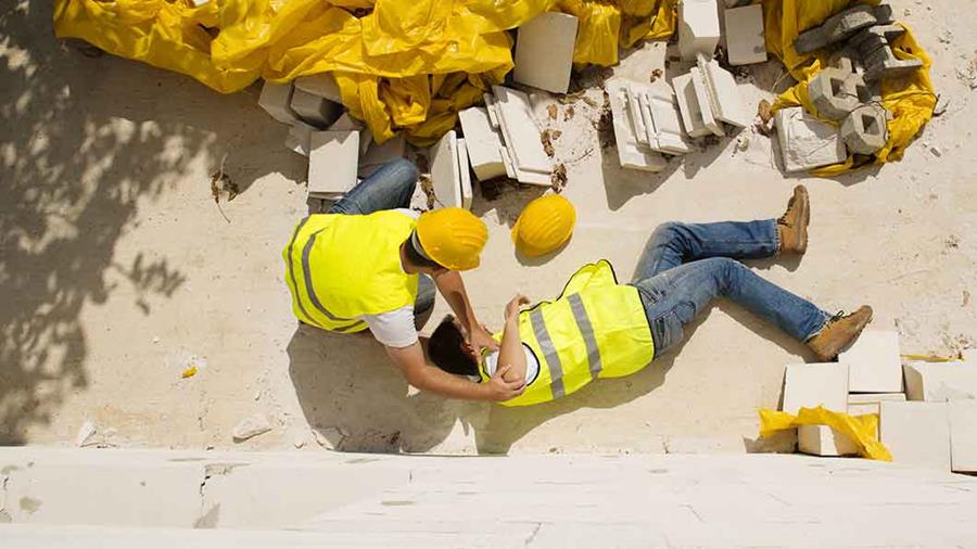 construction worker comforting a hurt coworker